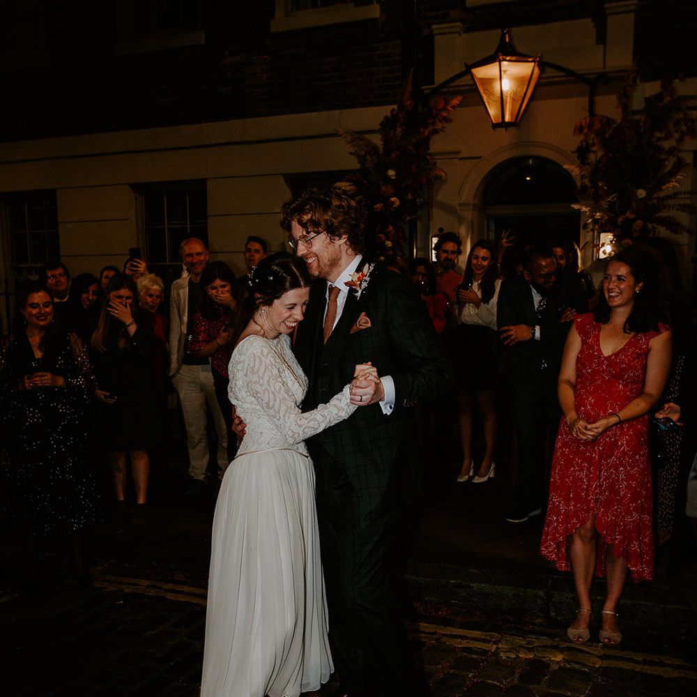 Bride and groom doing first dance at night outside The Zetter Townhouse 