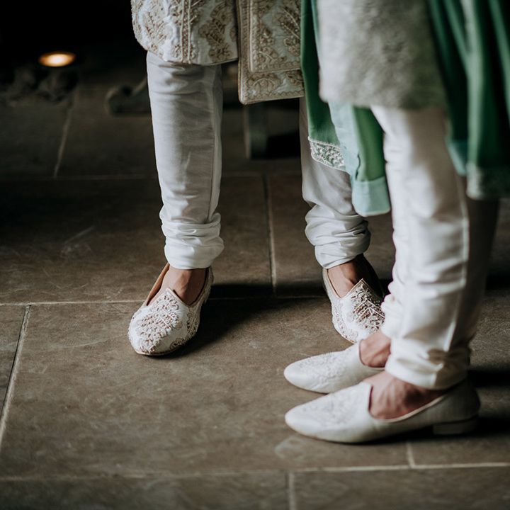 Grooms wear white and embellished shoes with matching sherwani's 