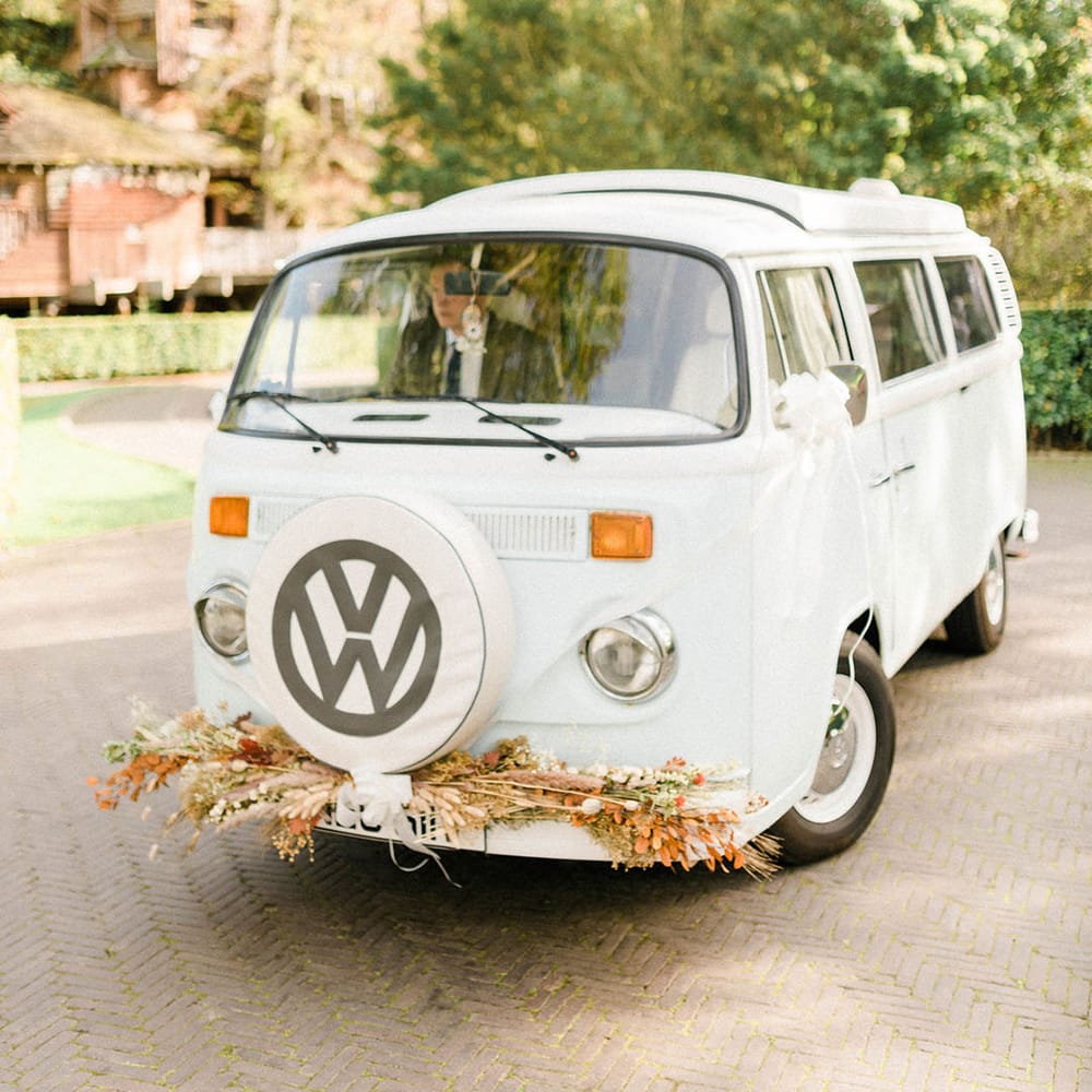 White VW camper van wedding transport complete with dried floral decor to the front 