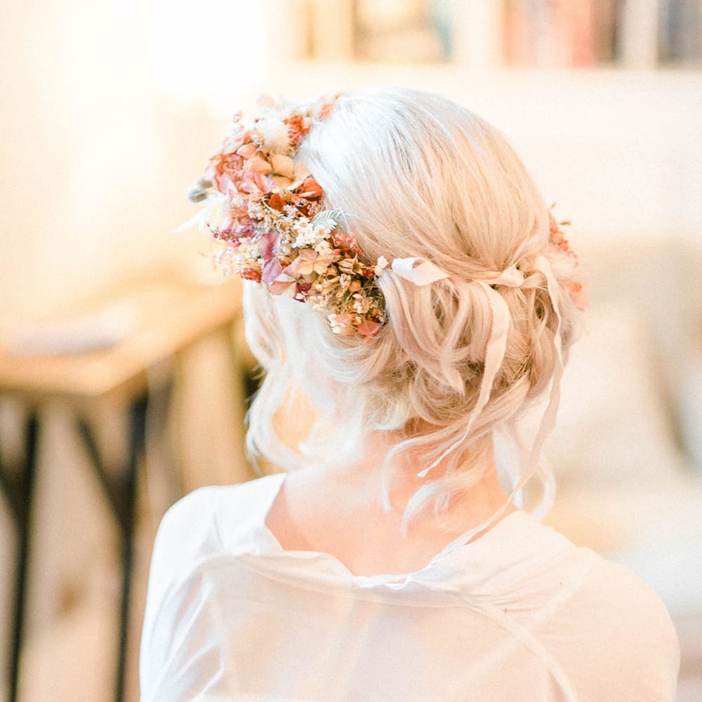 Bride wears dried flower crown in her blonde hair complete with silk ribbon 