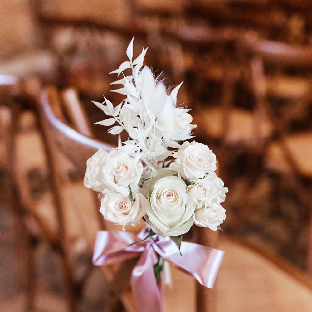 White rose chair back flower decor with pink ribbon 