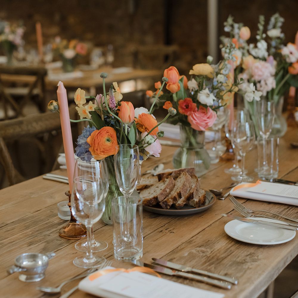 Pastel wedding candles and flowers decorating the tablescape for spring wedding theme 