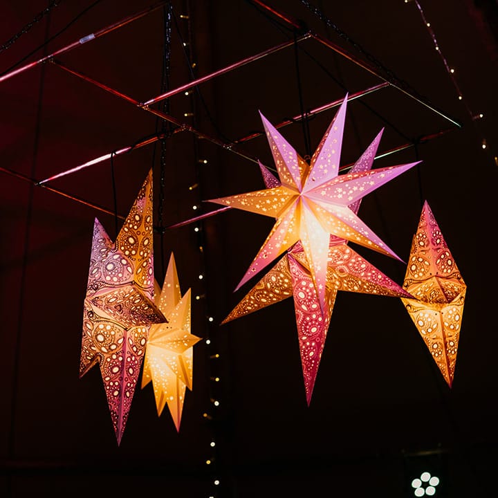 Intricate star lanterns decorating the wedding tipi 