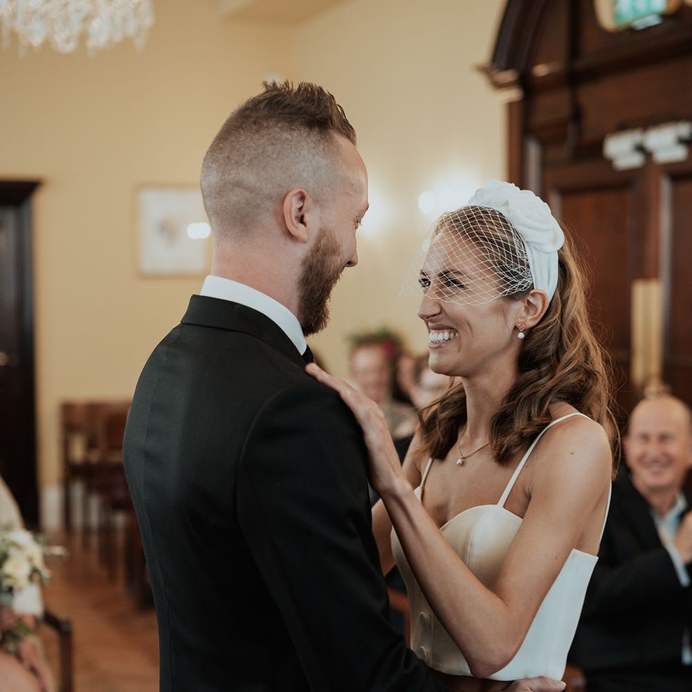 bride in a headband with birdcage blush veil bridal accessory at town hall wedding 