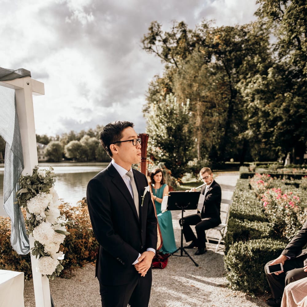 Groom standing at the altar in a dark suit