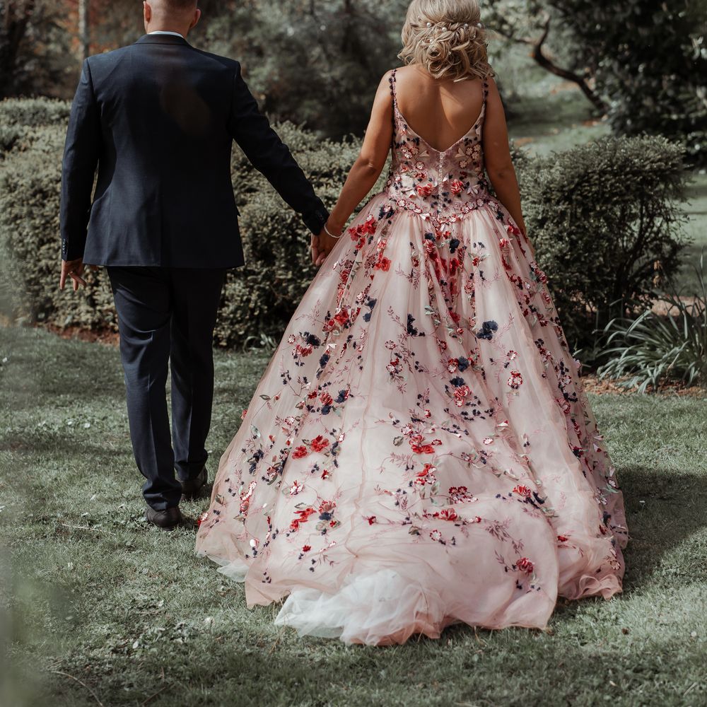 Bride & groom walk hand in hand on their wedding day