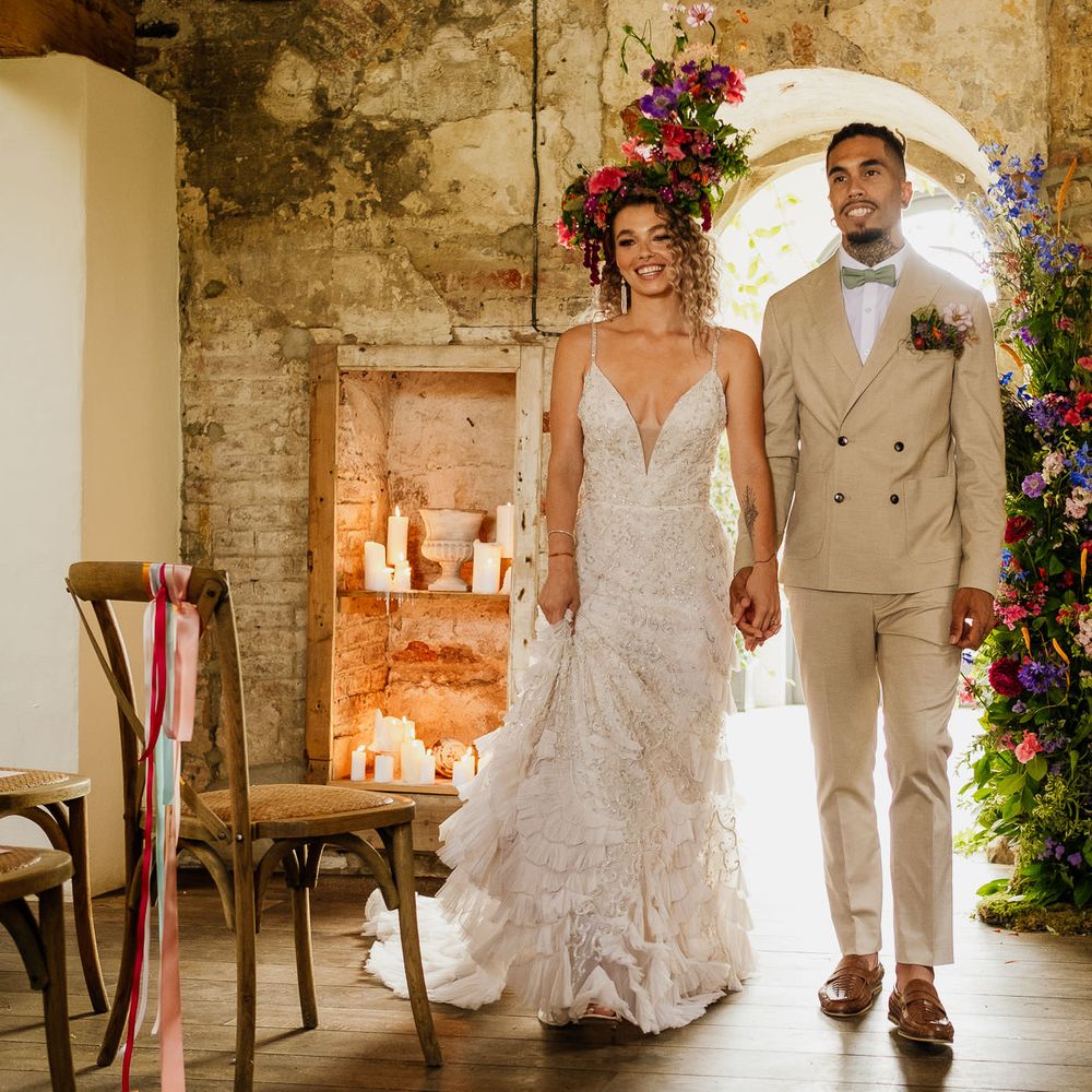 Colourful fiesta theme wedding with brightly coloured floral arrangement and flower crown and bride in an embellished wedding dress 