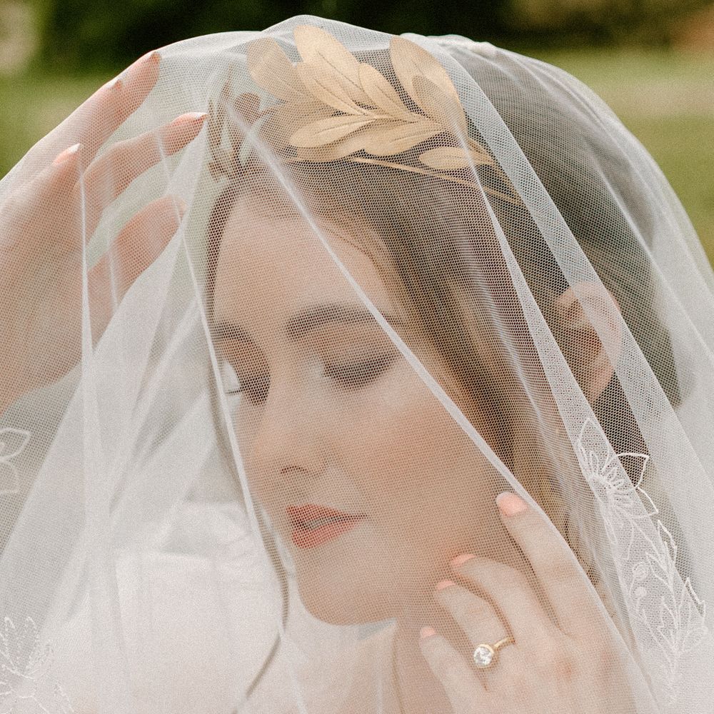 Beautiful bride with natural makeup wearing an embroidered wedding veil by Rebecca Anne Designs 
