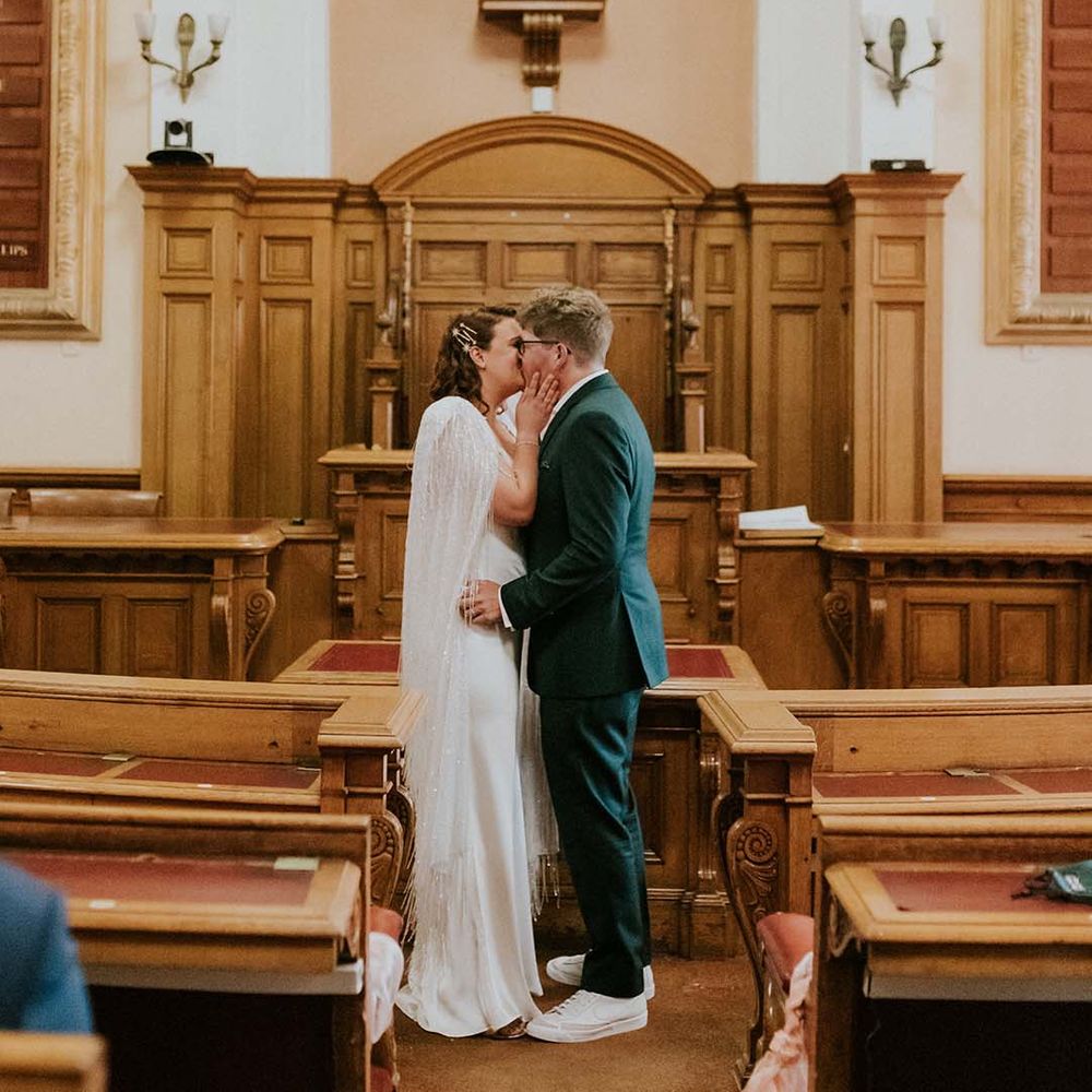 Bride & groom kiss at altar on their wedding day