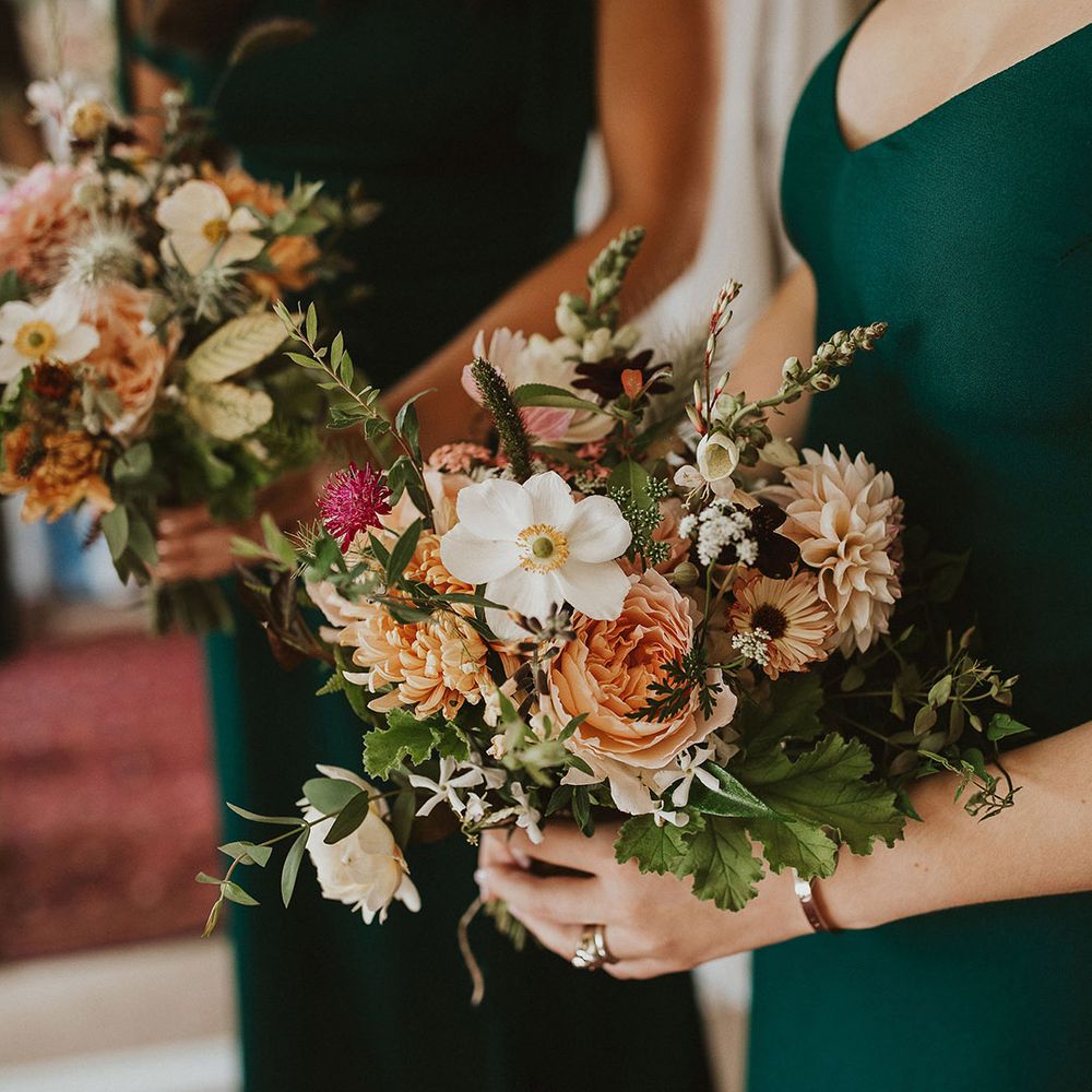 Colourful floral bouquet held by bridesmaids on wedding day
