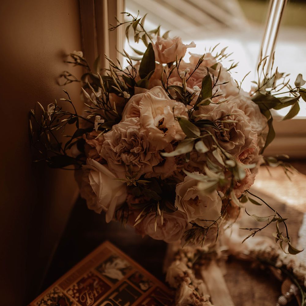 romantic pink wedding bouquet resting in the window 