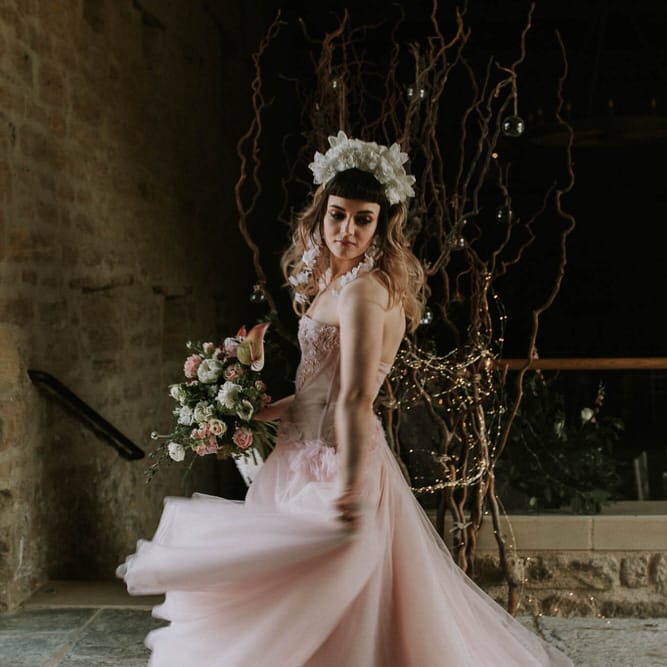 bride in a pink strapless wedding dress with corset bodice and tulle skirt twirling in Tithe Barn Hooton Pagnell