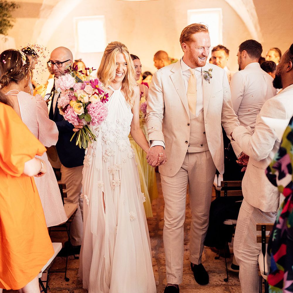 Bride and groom exit their wedding ceremony as a married couple 