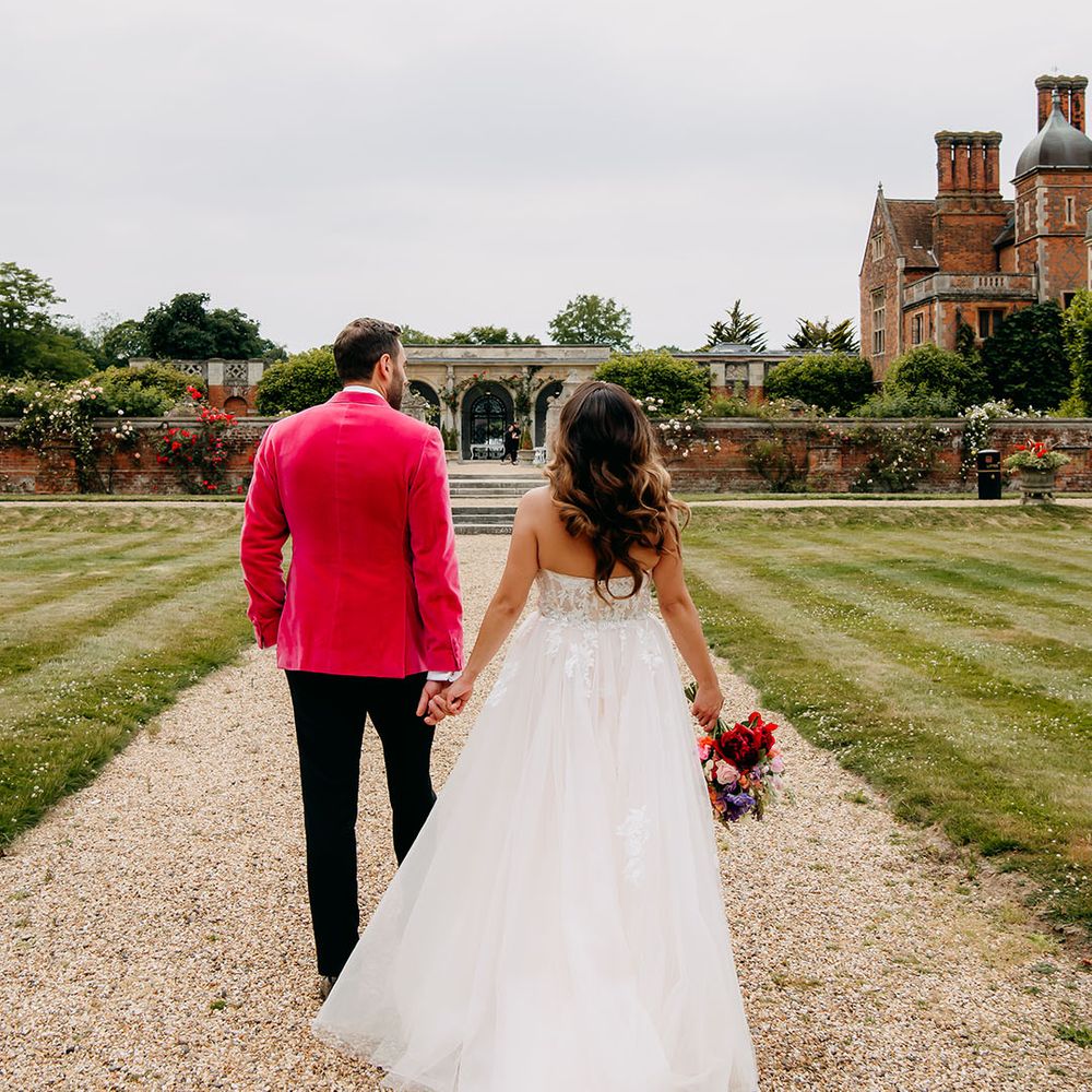 The bride and groom walk around the grounds of their country house wedding venue, North Mymms Park 