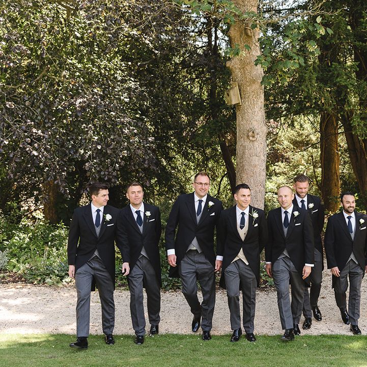 Groomsmen in matching black, grey, and navy morning suits with the groom for the luxury The Manor House wedding 