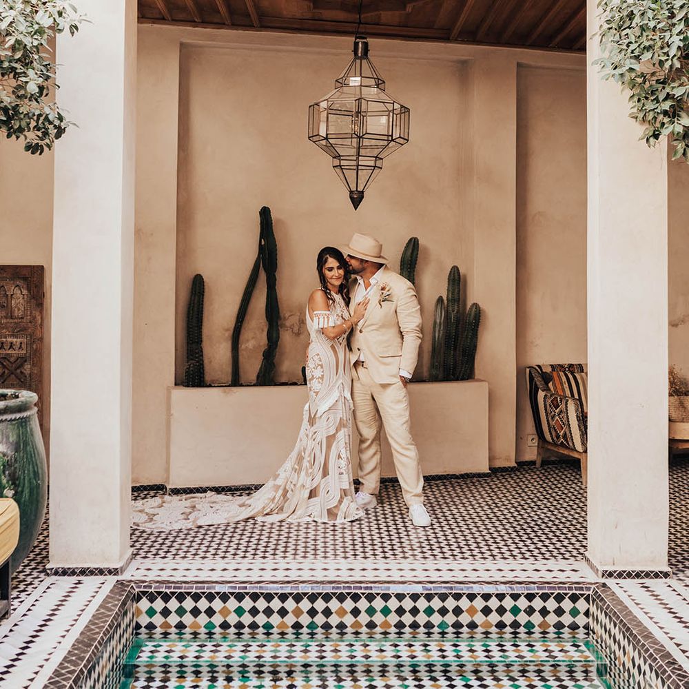 Groom reacts to seeing the bride in her dress for the first time and embraces her 