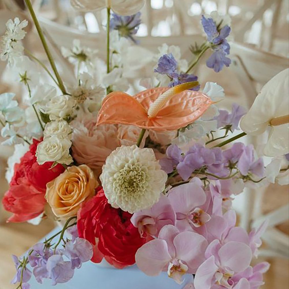 Pastel wedding flowers in shades of lilac, white, orange, red and pink by Alba Turnbull Photography