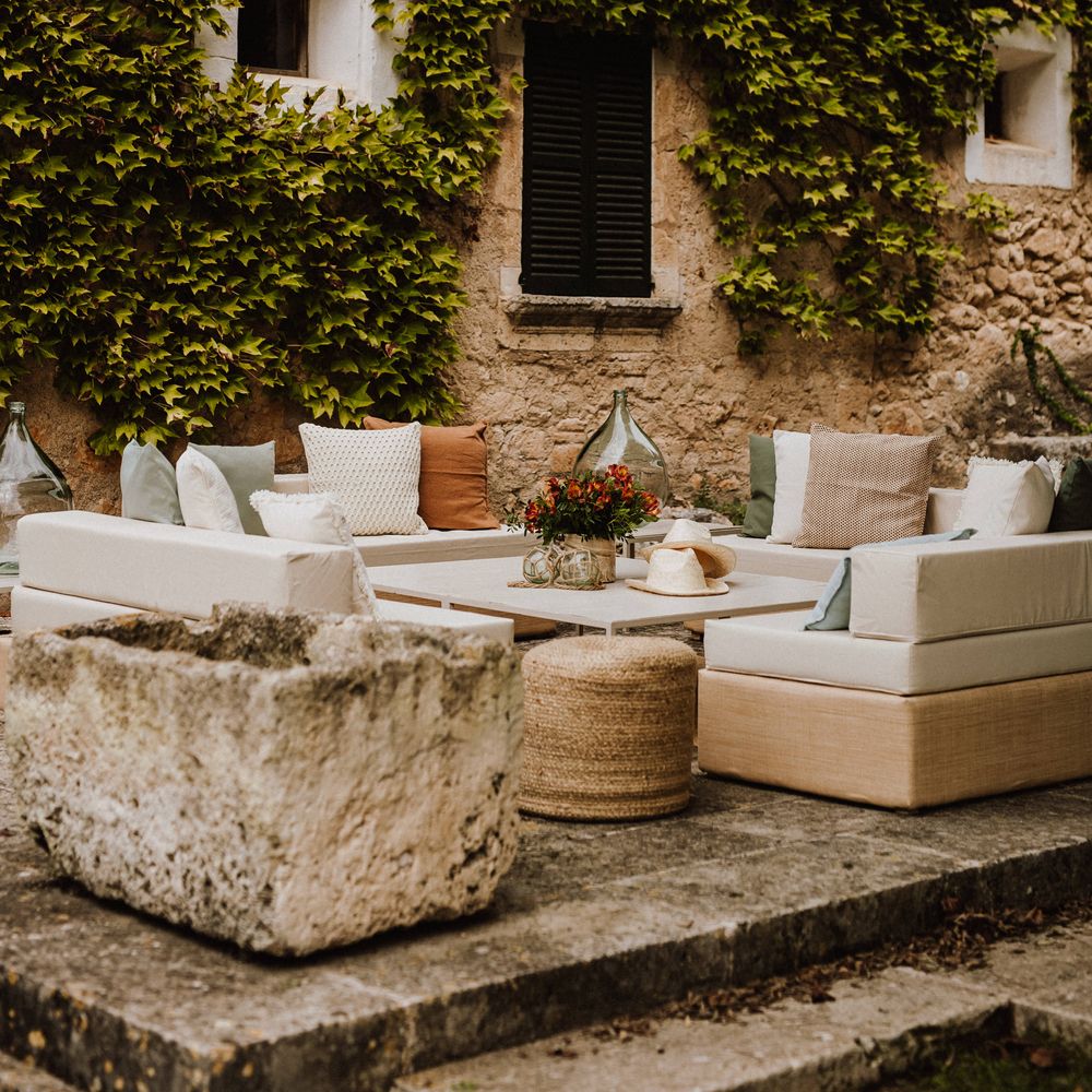 Outdoor setting in Mallorca with white corner sofa furniture and scatter cushions