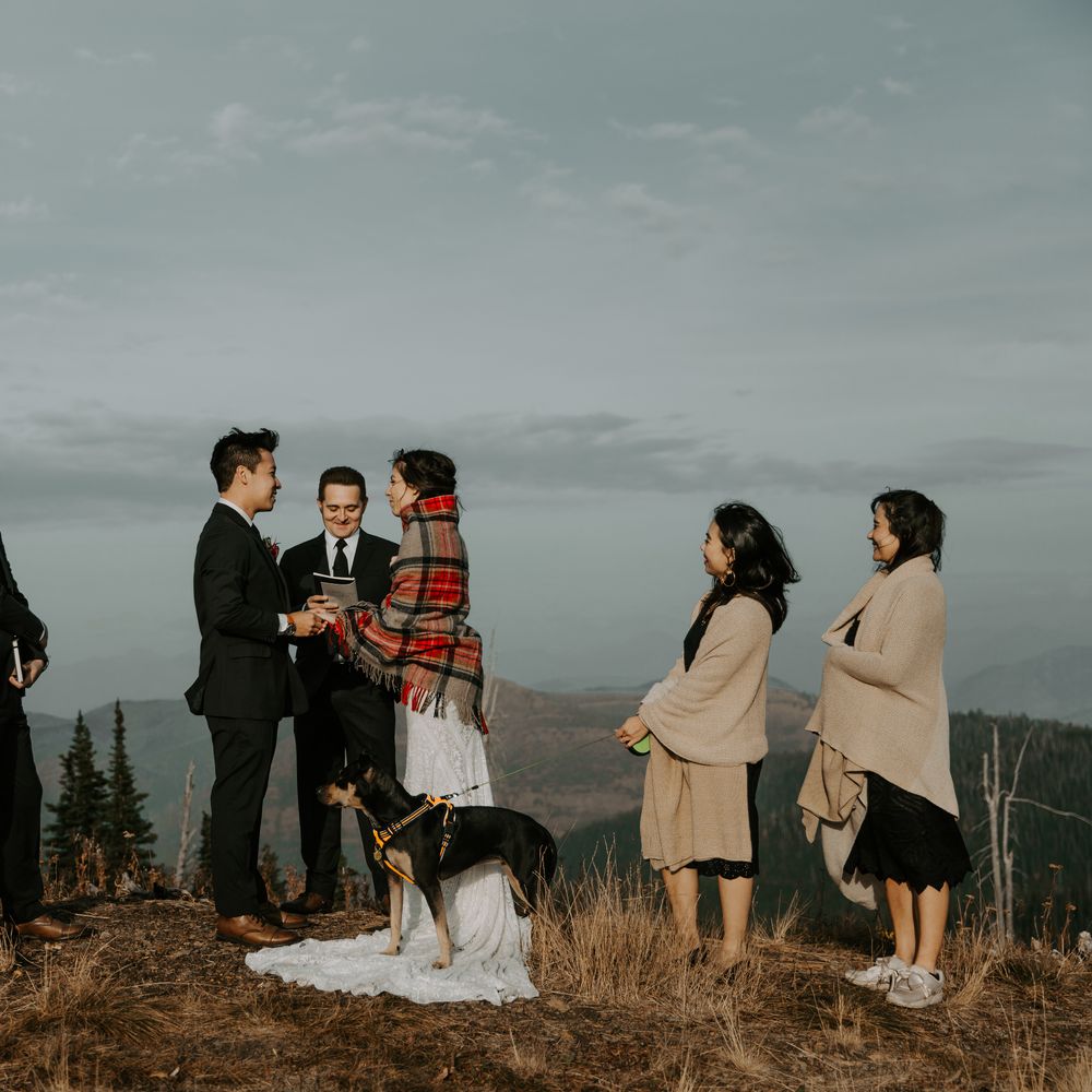 Bride & groom during wedding ceremony atop Montana mountain