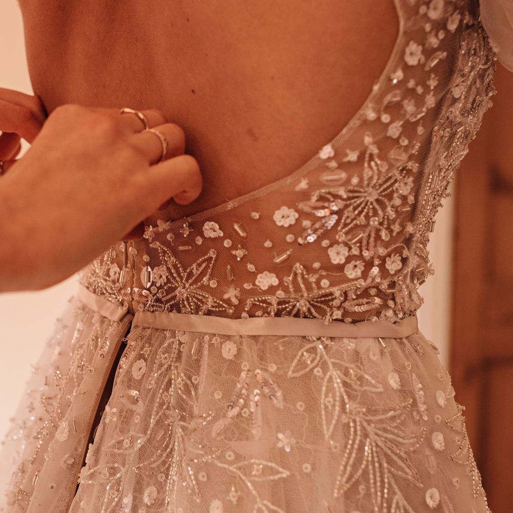 Wedding guests buttons up the back of embroidered Julie Vino wedding dress
