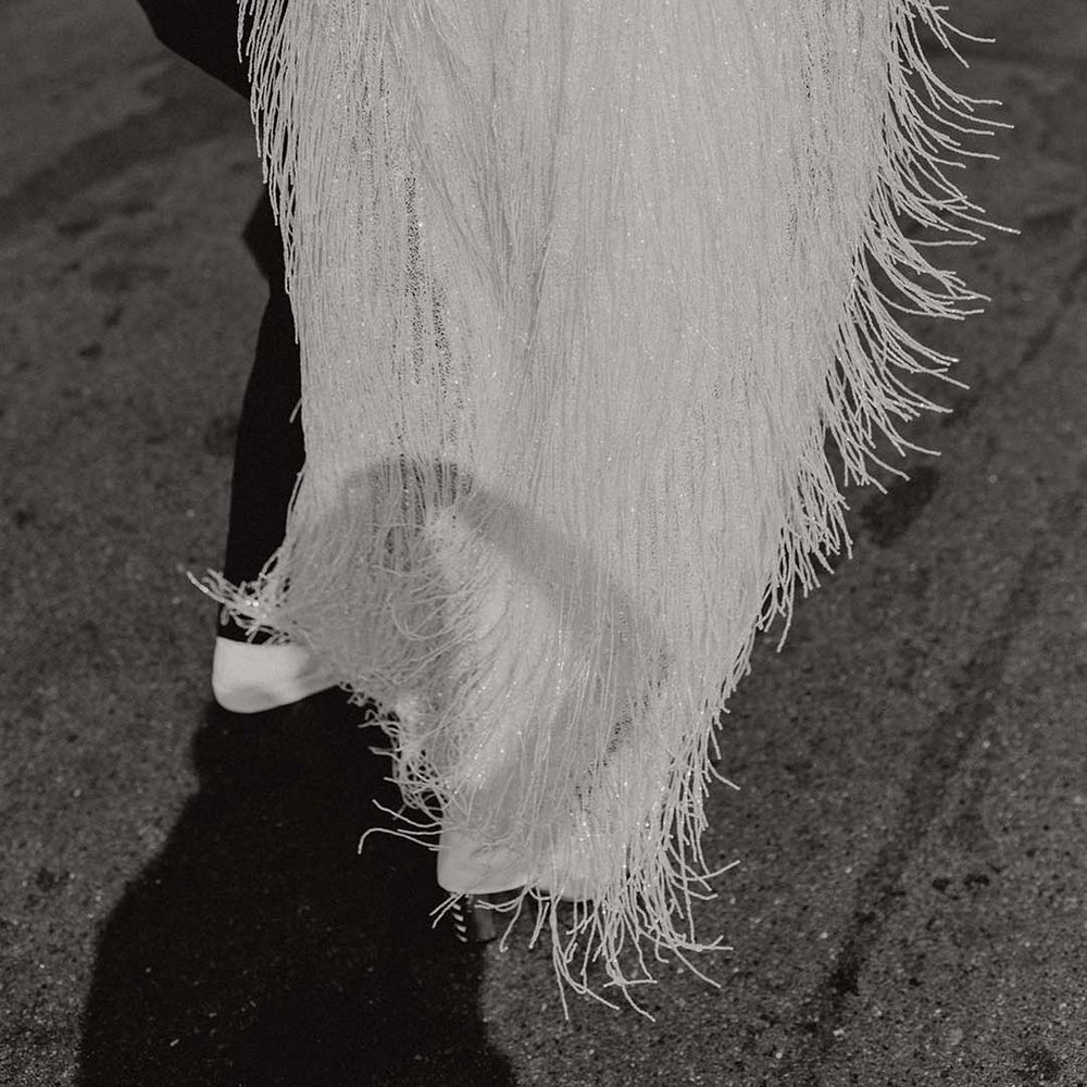 Bride wears tasselled Halfpenny London wedding cape