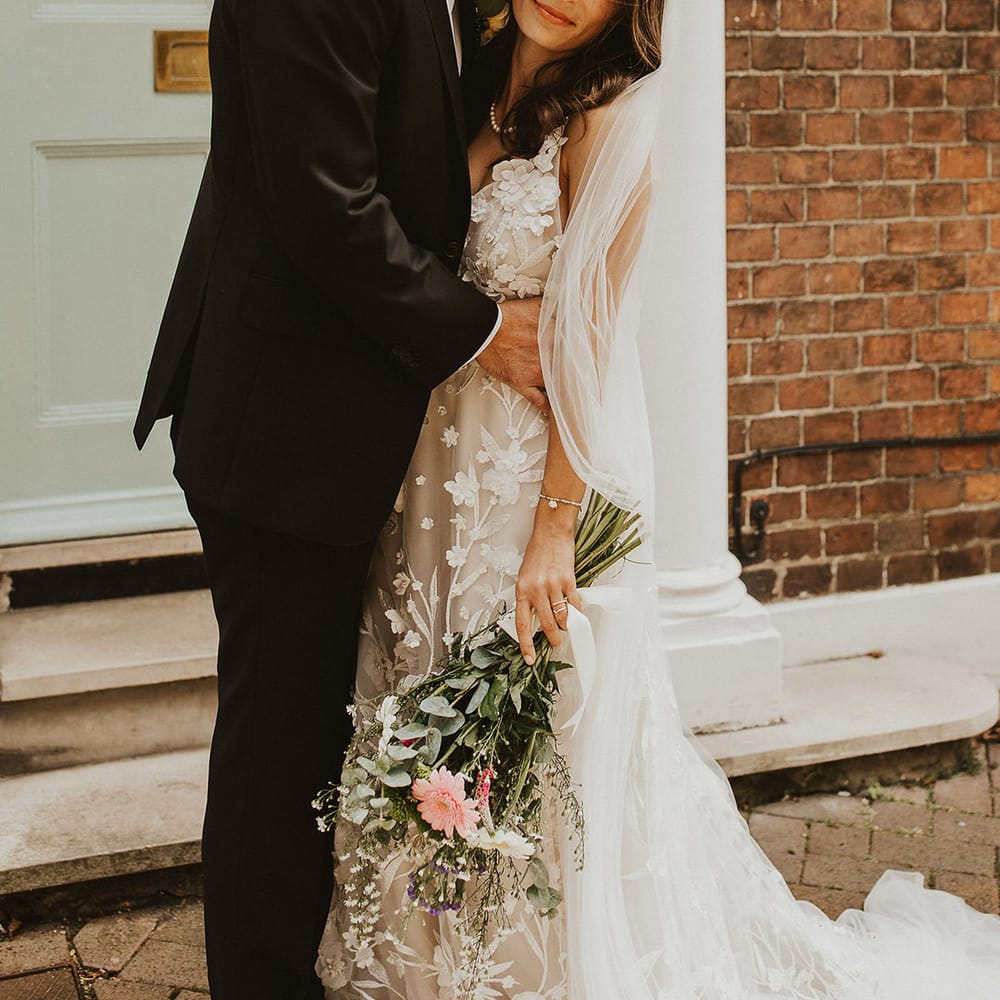 Groom kisses his brides forehead on their wedding day