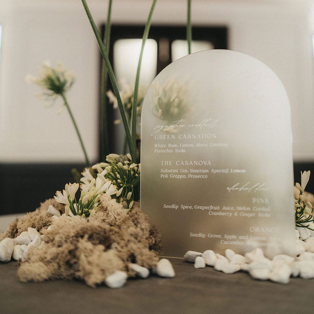frosted acrylic wedding sign and white and green wedding flowers 