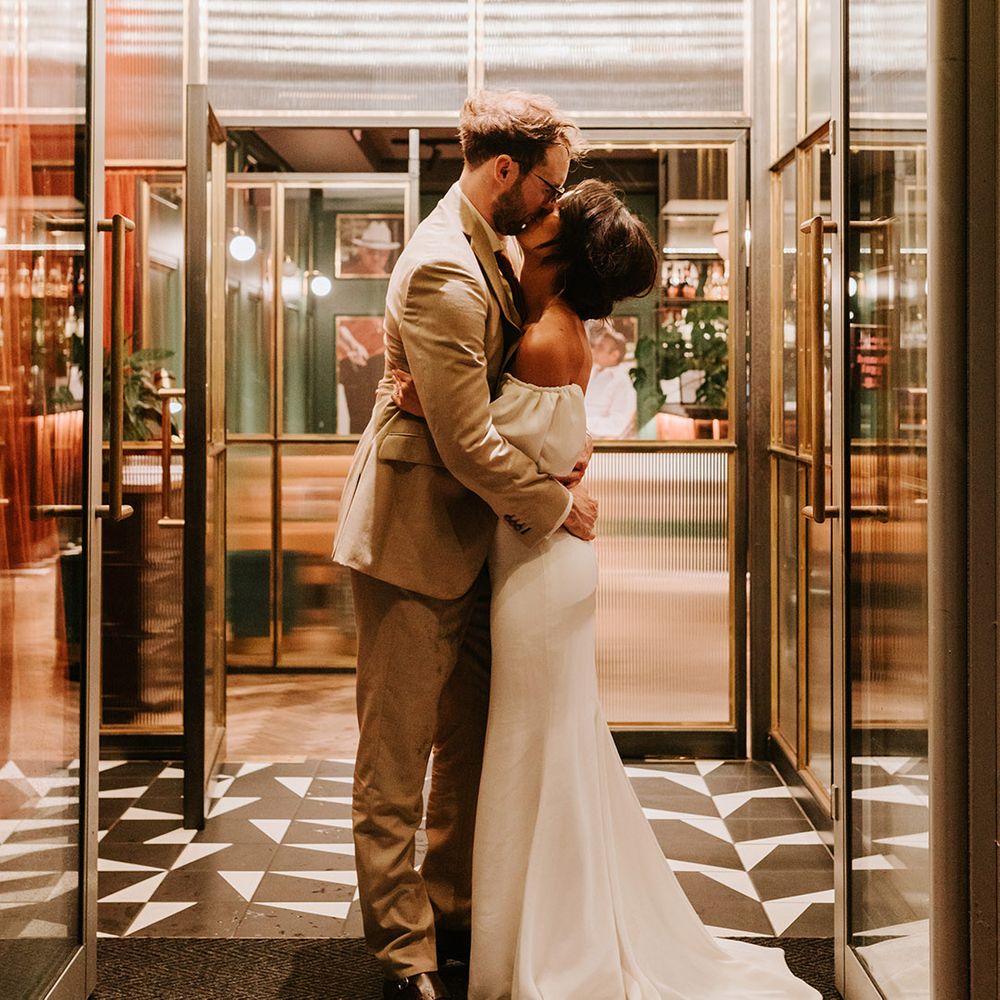 Bride and groom kiss at their industrial wedding venue, Holmes Mill