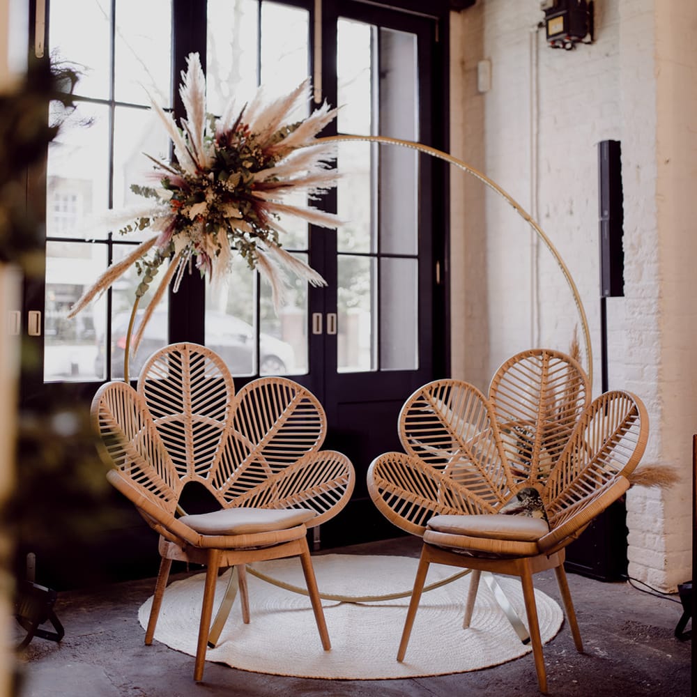 Wooden Moorgate private seating area with dried flower decor and two wooden flower rattan chairs