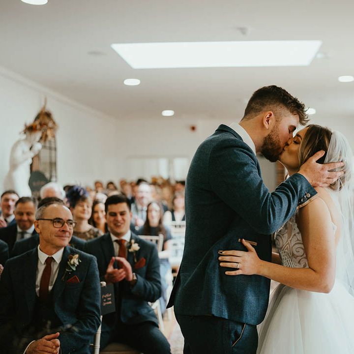 Bride and groom share their first kiss as a married couple 
