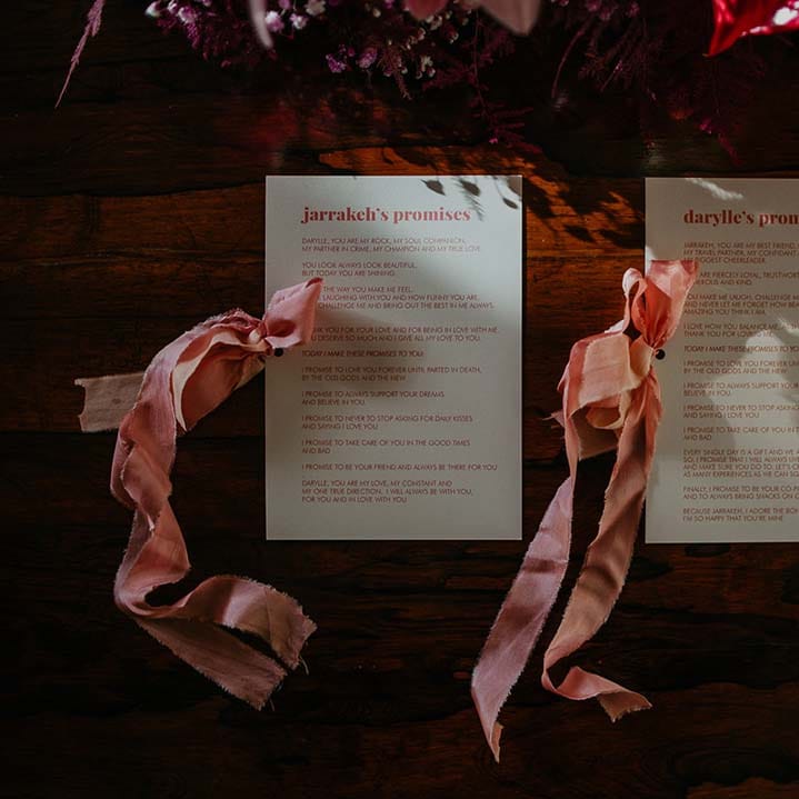 Retro wedding vows stationery in baby pink lettering with baby pink ribbon on off white paper 