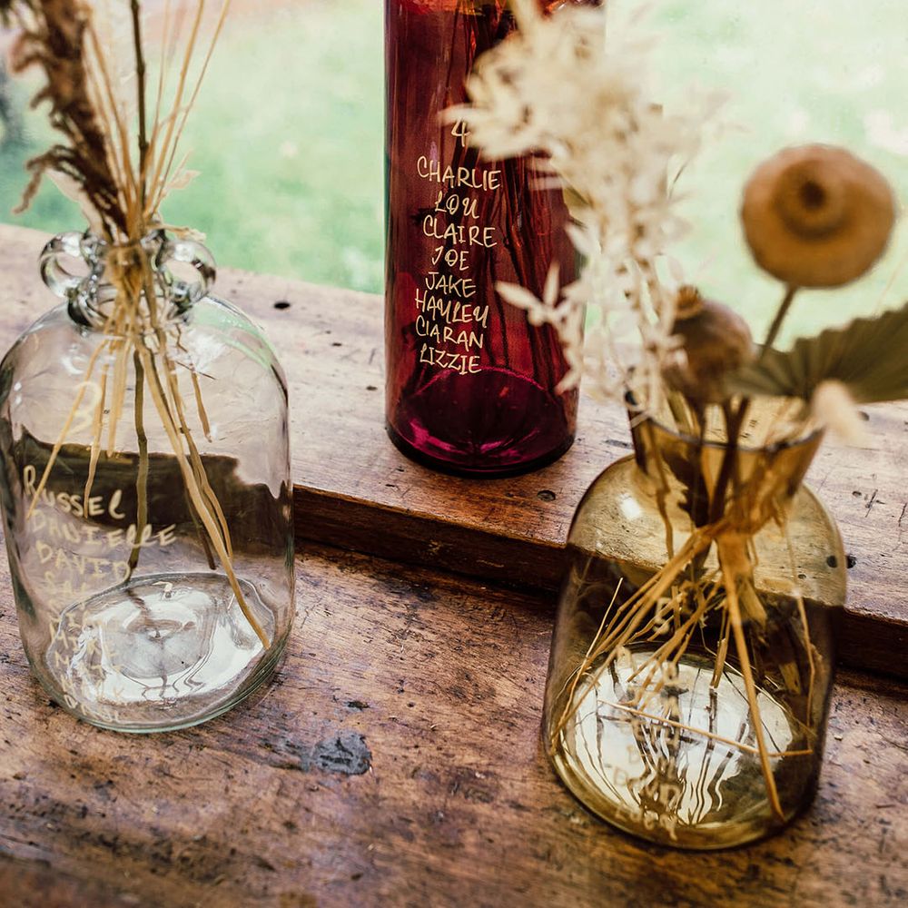 Vintage styled vases filled with pampas grass arrangements 
