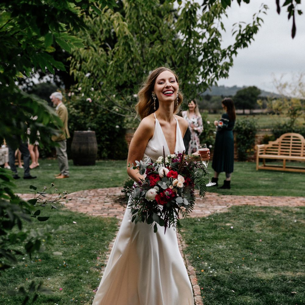 Beautiful bride with read and white bouquet at Micro wedding