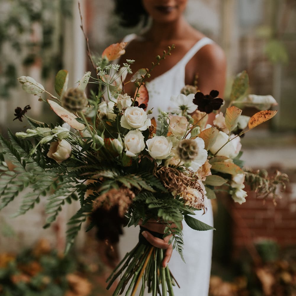 Autumn wedding bouquet with green, brown and white flowers and foliage 