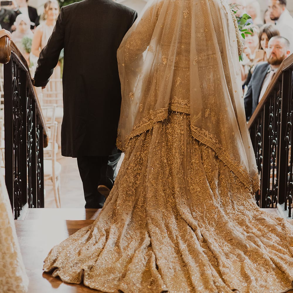 Wedding ceremony bridal entrance in gold dress and veil 