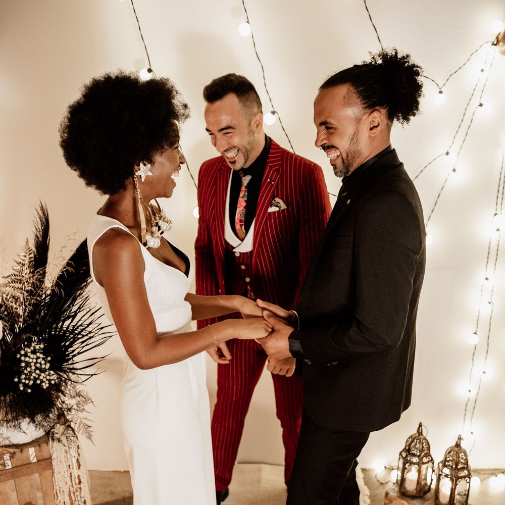 Bride & groom hold hands during wedding ceremony