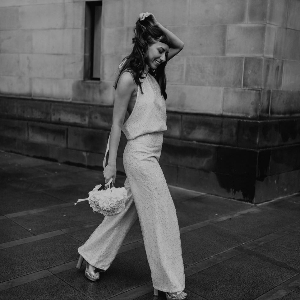 City bride in wide leg sequin trousers, platform shoes and halter neck top 