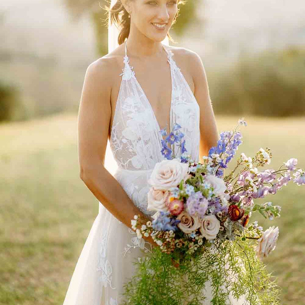 Bride in plunging halterneck dress with gorgeous oversized bouquet