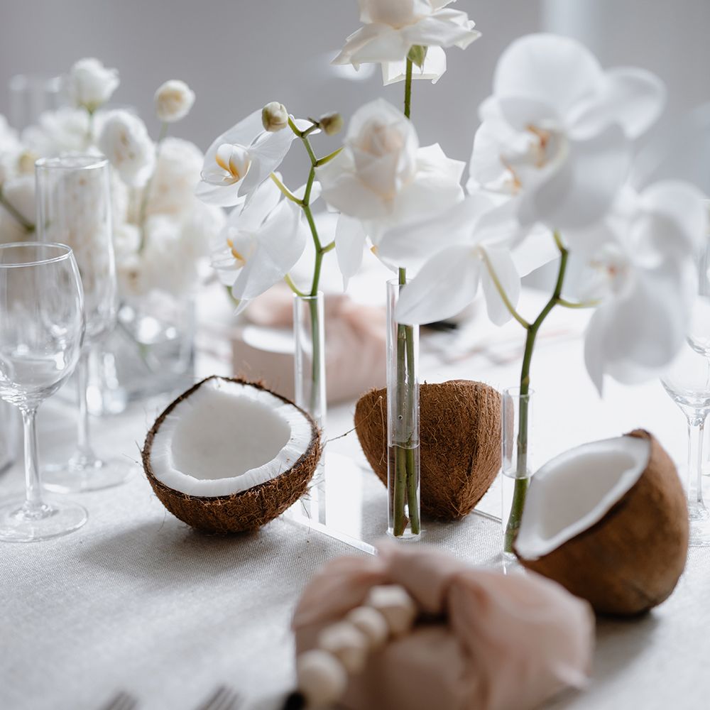 Asian Lesbian wedding table decor with coconuts and orchids 