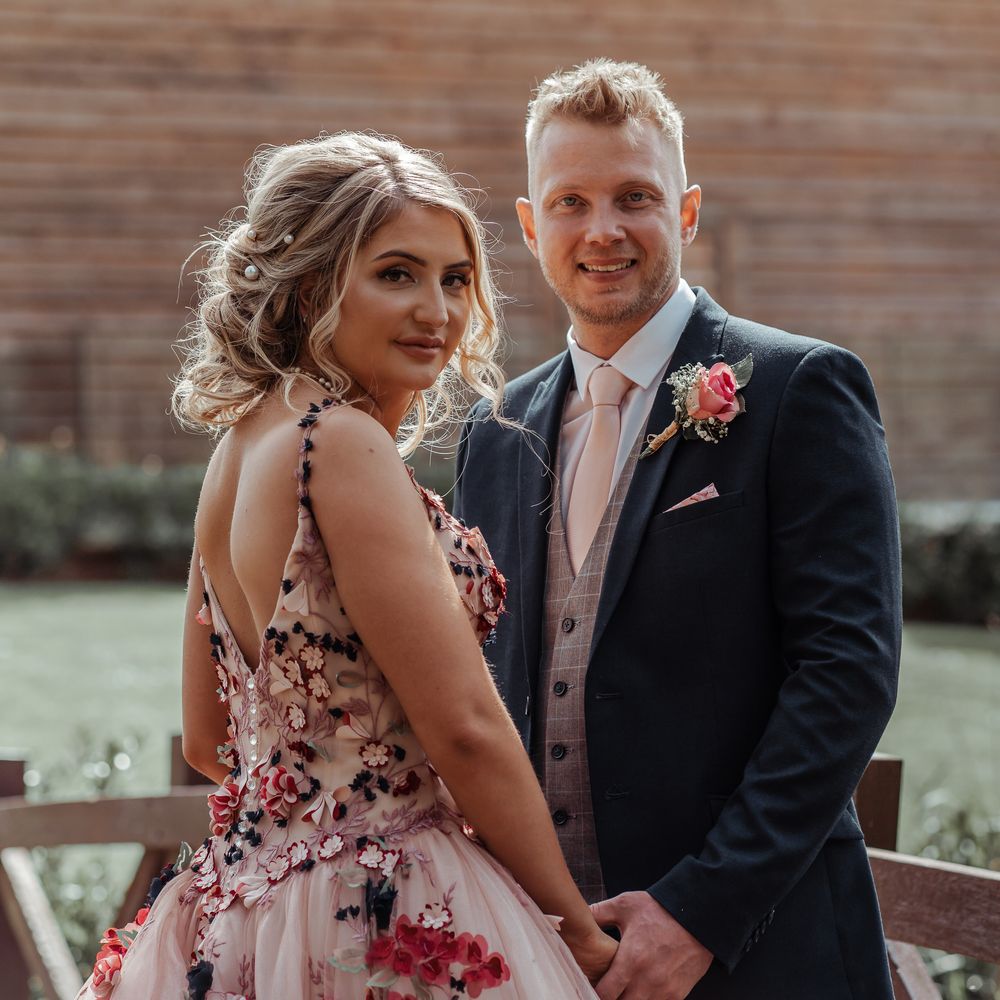 Bride & groom hold hands on their wedding day for post wedding photoshoot