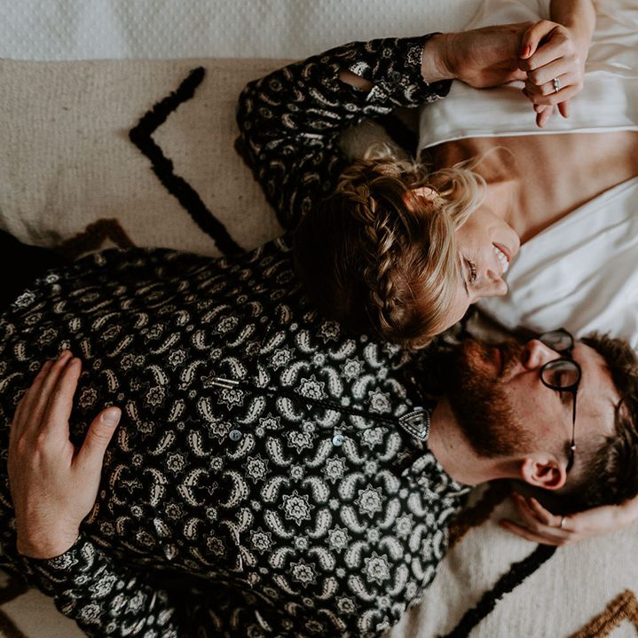 Bride & groom lay down beside one another on their wedding day