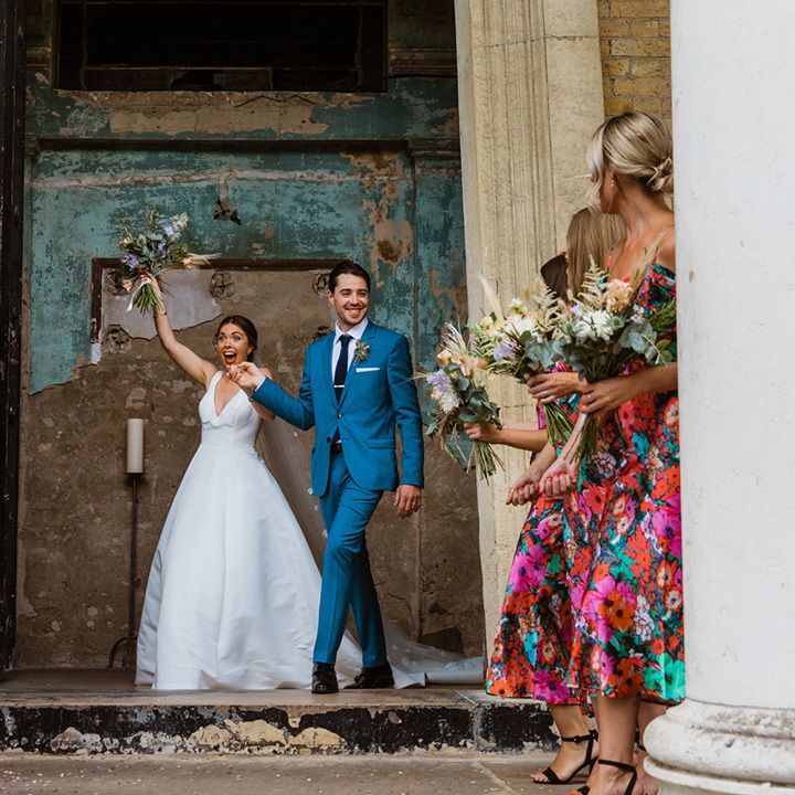 Bride and groom exit happily from wedding venue as husband and wife