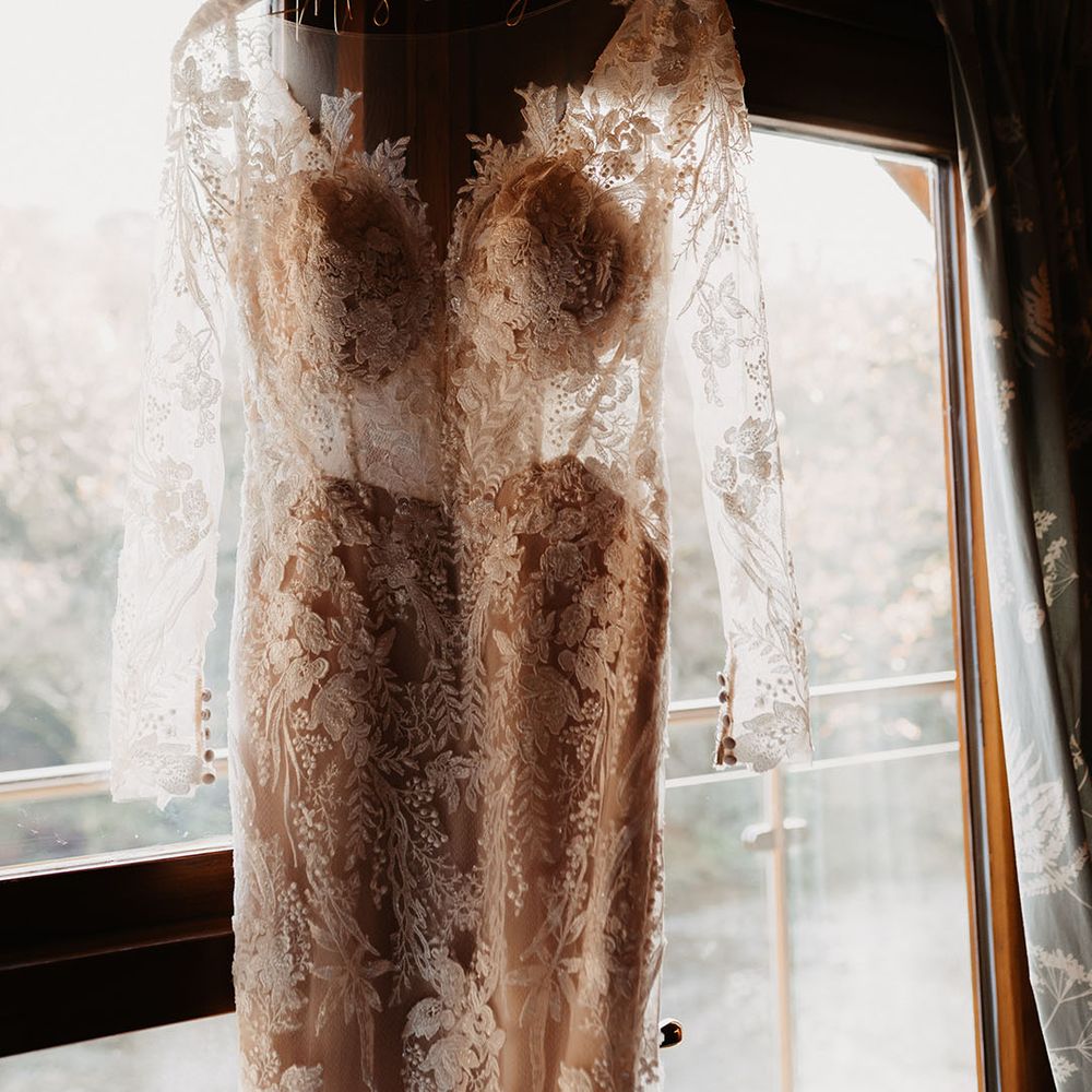 Bride's wedding dress with lace details, long sleeves and illusion neckline for winter wedding at Hidden River Barn