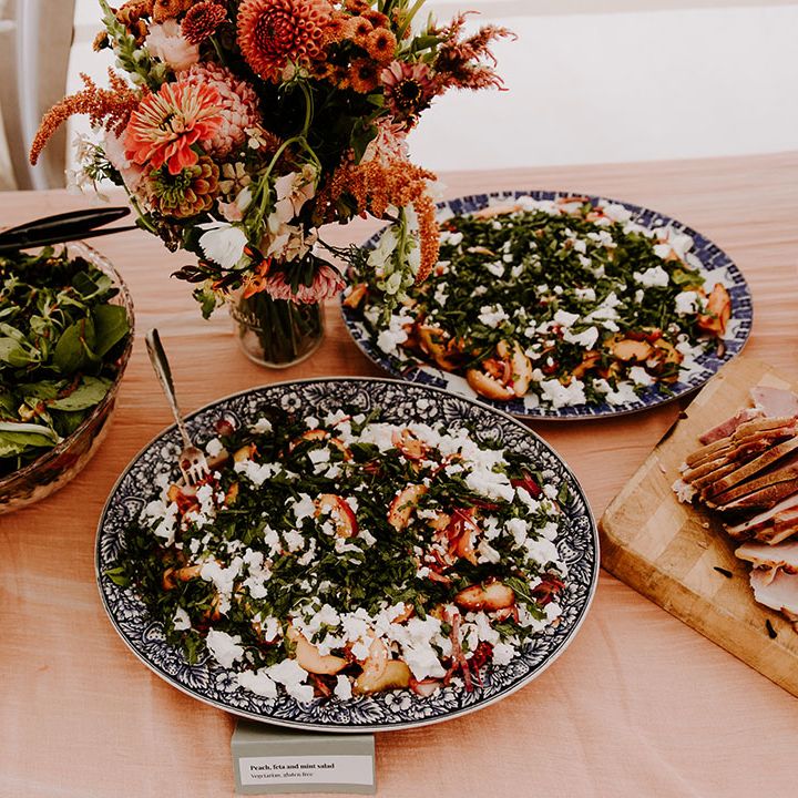 Colourful buffet styled food for wedding reception with Autumnal bridesmaid dresses