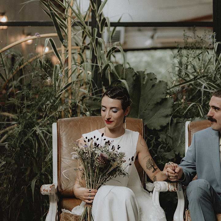 Lisa in pre loved wedding dress sits beside Gabriel in powder blue Gucci suit 