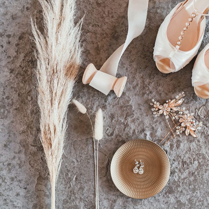 Bejewelled white wedding shoes by Rainbow with diamond earrings and sparkling hair accessories 