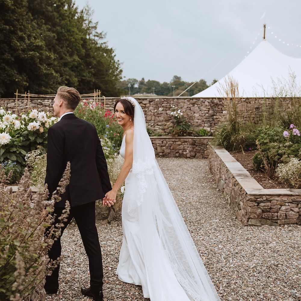 Cute couple portrait of the bride and groom walking around the Casterton Grange Estate wedding venue 