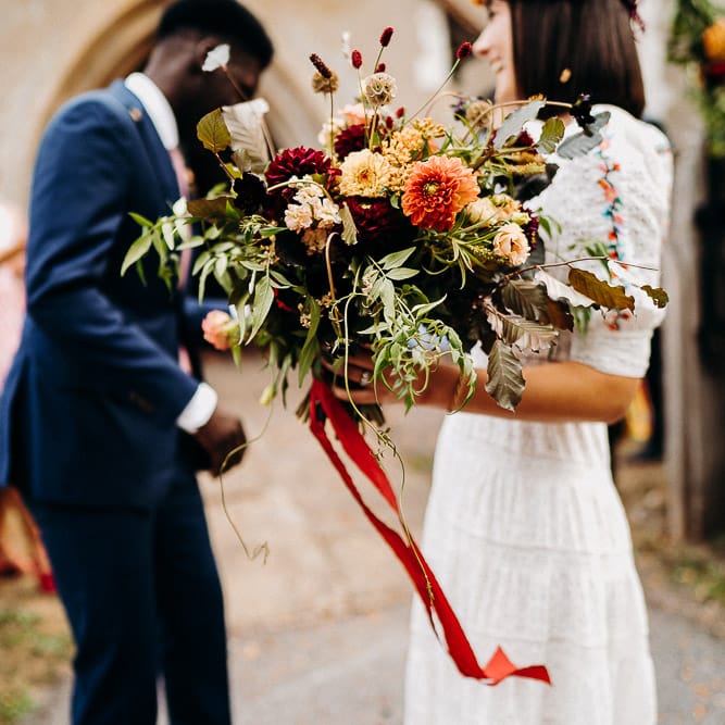 hand tied red and orange dahlia and wildflower wedding bouquet 