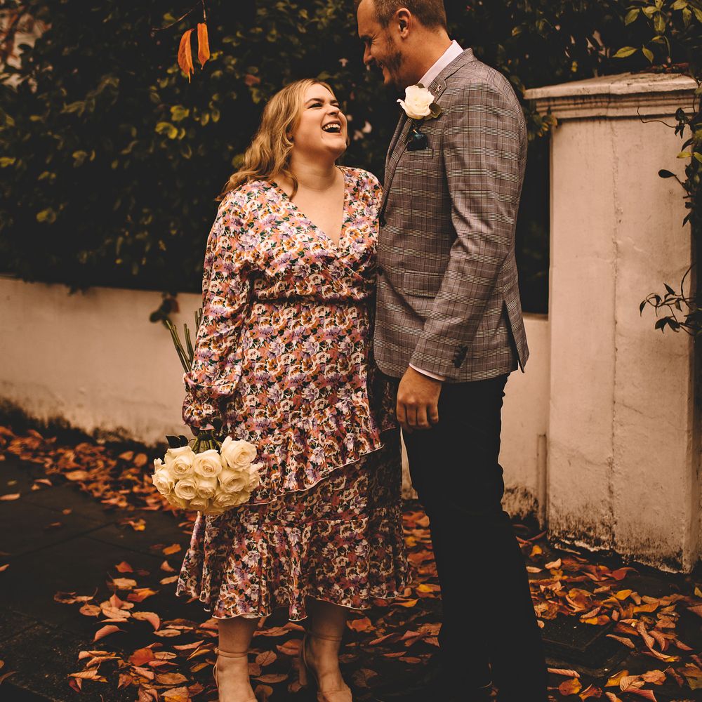 Bride looks up lovingly at groom as she wears ASOS floral wedding gown 