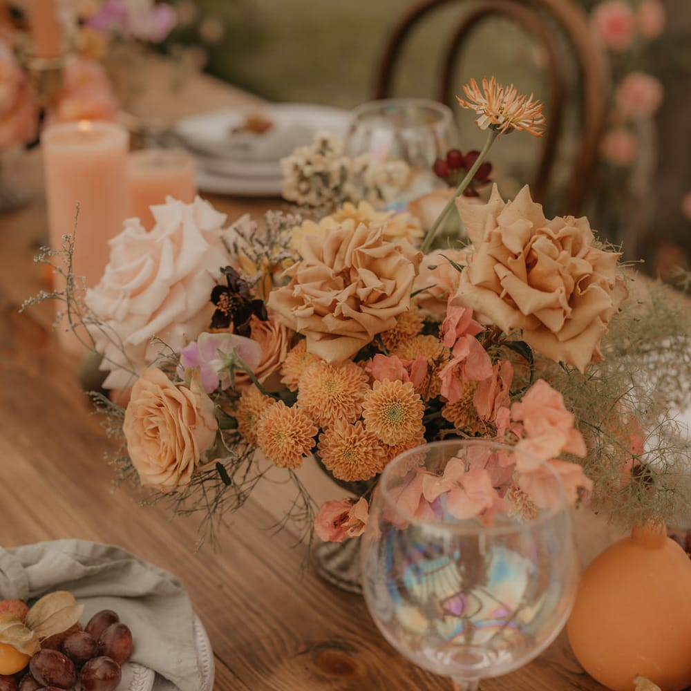 Pastel orange wedding flower arrangement with roses and dahlias 